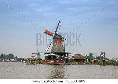 Traditional, Authentic Dutch Windmills At The River Zaam In Zaanse Schans Village.