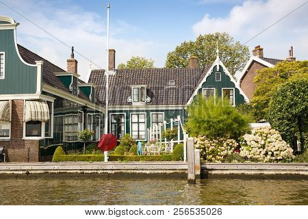 Traditional, Authentic Dutch Houses And Flowers At The Canal.