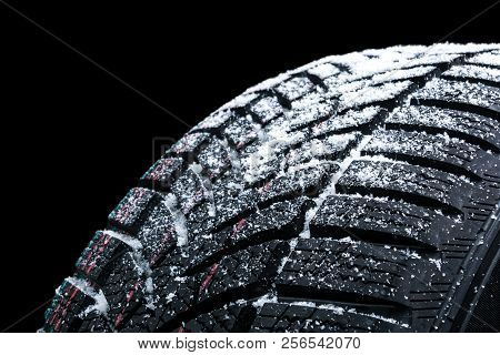 Winter Car Tires With Snow Wheel Profile Structure On Black Background - Close Up.