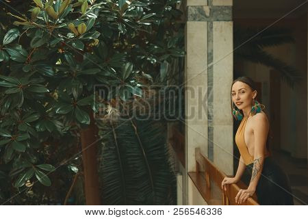 Pretty Young Woman Standing In Hotel Balcony, Looking Out Enjoyi