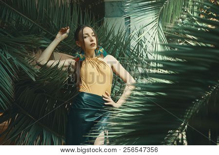 Attractive Young Woman Among The Tropical Plants.