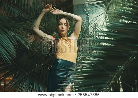 Attractive Young Woman Among The Tropical Plants.