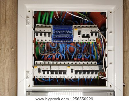 Close Up Of White Frame Panel Electrical Switch Board, With Colourful Cables Automatic Circuit Switc
