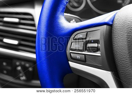 Cruise Control Buttons On The Blue Steering Wheel Of A Modern Car. Car Interior Details. Car Detaili