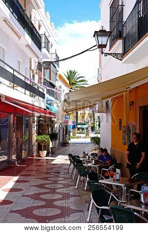 Ayamonte, Spain - June 11, 2017 - People Relaxing At A Pavement Cafe Along Calle Angustias, Ayamonte