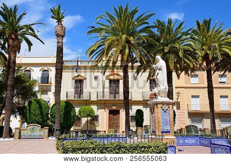 Ayamonte, Spain - June 11, 2017 - Statue In The Plaza De La Laguna With The Town Hall To The Rear, A