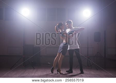 Young Couple Dancing Social Danse Kizomba Or Bachata Or Semba Or Taraxia In Dancing Class Background