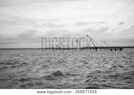Ancient Chinese fishnets in the sea of Cochi, Kerala, India. Black and white photo.