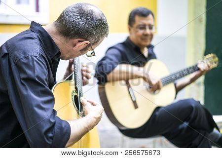Two Fado Guitarists With Acoustic And Portuguese Guitars