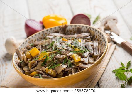pizzocheri pasta with mushroom pepper and mint leaves