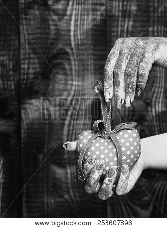 Female Hand Smeared In Golden Paint Or Glister Holding Handmade Pink Polka Dots Valentine Heart On B