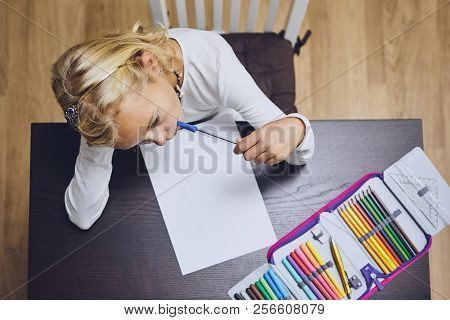 Cute Girl Comtemplation About Her Homework For Elementary School At Home.