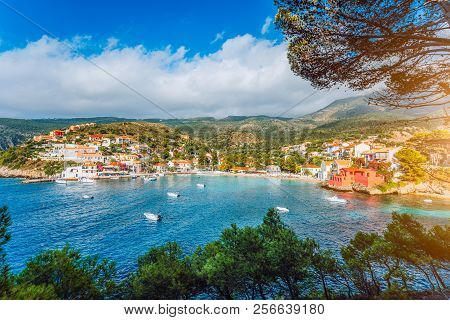 Assos Village, Kefalonia. Greece. White Yachts And Boats Staying At Anchor In Azure Water Of The Bay