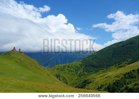 Ancient Gergeti Trinity Church Tsminda Sameba In Caucasus Mountains Near Mount Kazbek And Gergeti Gl