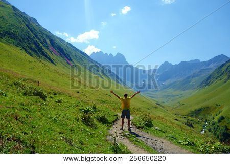 Grand Alpine Mountain Range With A Young Man On A Hiking Trail Leading From Juta To Chaukhi Pass, Ca