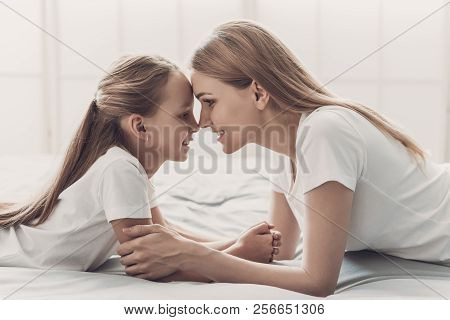 Young Happy Mother And Little Doughter Together. Beautiful Smiling Woman Spending Time With Cute Ado