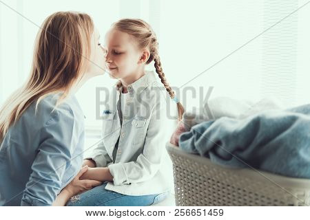 Young Happy Mother Kissing Little Daugther In Nose. Beautiful Woman Kissing Cute Smiling Child In No