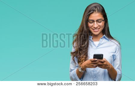 Young beautiful arab woman texting using smartphone over isolated background with a happy face standing and smiling with a confident smile showing teeth