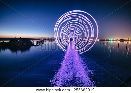 Amazing Laser Fireshow Performance In The Night Blue Sky With Reflections In The Sea Water