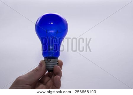 Blue Lamp Without A Plafond In Hand On A White Background