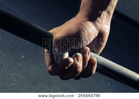 Closeup Of Man's Hand Gripping A Barbell