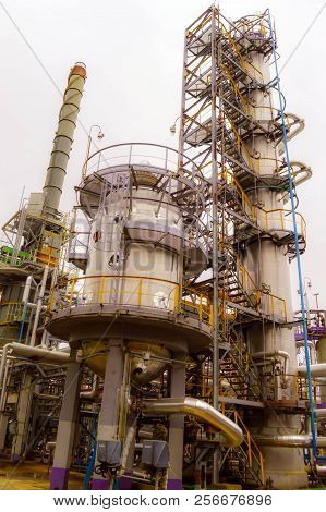 Installation For Processing Oil With Columns And Pipes. Refinery. Oil And Gas.