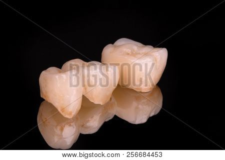 Dental Ceramic Veneers And Crowns Isolated With Mirror Background.
