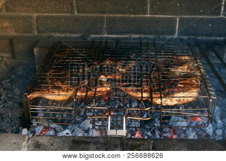 Grilled Chicken Tabaka On The Flaming Grill