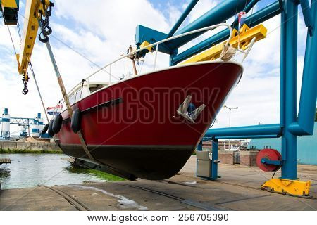 Boat crane lifting a motorboat