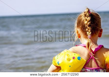 Happy Little Girl With Floaties Floaties Preparing To Swim In The Ocean