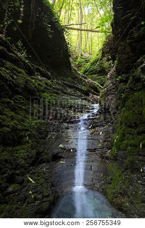 Cascade Falls Over Mossy Rocks. Spring In Forest.magic Lightnings.deep Forest Athmosphere.