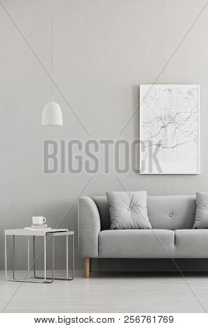 Real Photo Of Map Poster Hanging On The Wall In Living Room Interior With Grey Sofa, Metal End Table