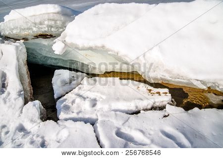 Blocks Of Ice Melt In The Spring On The Shore Of The Pond