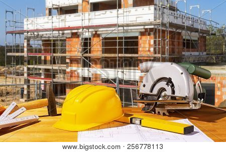 Helmet, Tools And Circular Saw With A Shell In The Background