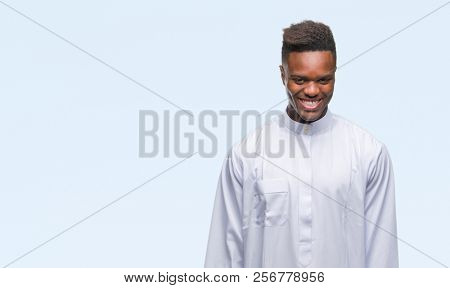 Young arabic african man wearing traditional djellaba over isolated background with a happy and cool smile on face. Lucky person.