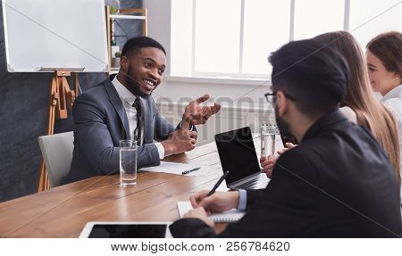 Cheerful African-american Applicant Talking At Job Interview To Hr Comission