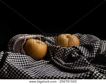The Chinese Pear Put On Black And White Table Cloth,blurry Light Around