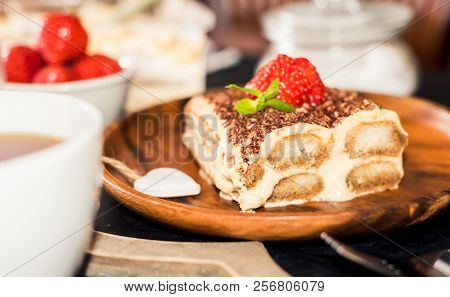 Tiramisu - Classical Dessert Garnished With Strawberry And Mint