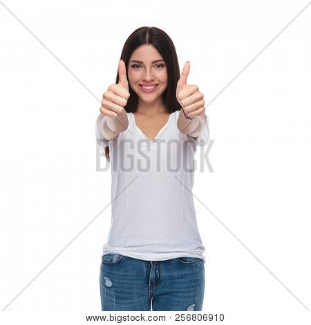 portrait of casual woman making ok sign whilte standing on white background and smiling
