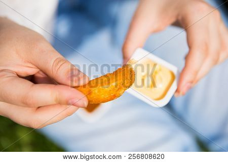Woman Keeping Suace With Potatoes In Hands