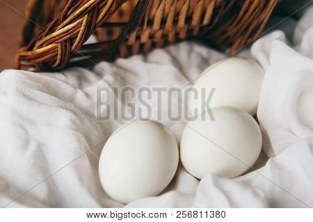 White Chicken Eggs With Wodden Basket On A Tablecloth