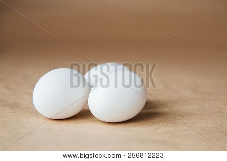 White Chiken Eggs On Brown Background On A Table