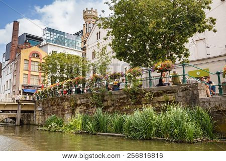 Ghent, Belgium - August 14, 2015 - Old Colorful Traditional Houses Along The Canal And The Relaxing 