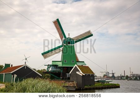 Traditional, Authentic Dutch Windmills At The River Zaam In Zaanse Schans Village.