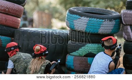 Kids Playing Lasertag On Special Polygon With Shelter
