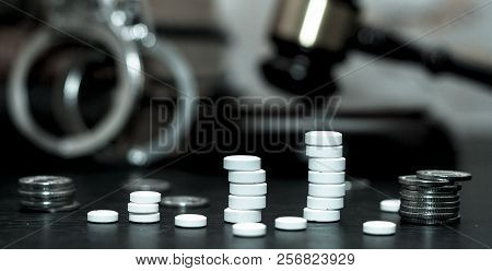 Judge's Gavel With Handcuffs, Drugs On Wooden Table