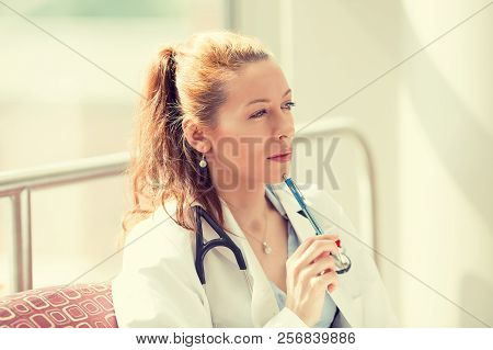 Portrait Of A Confident Woman Doctor Sitting In Her Office