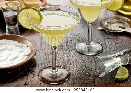 Delicious Tequila And Lime Margaritas On A Bar Top With Tortilla Chips And Pico De Gallo.