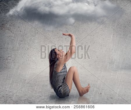 Disappointed Young Businesswoman With Raincloud Above Her Head Isolated On Grey Background. Bad Luck