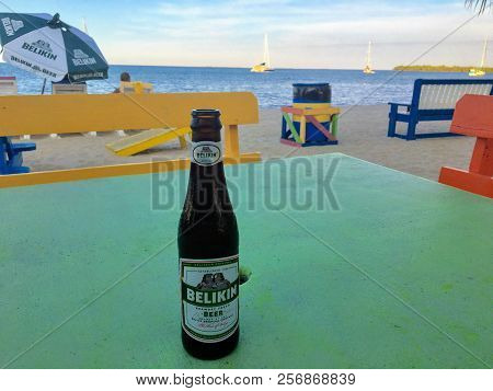 Placencia, Belize - May 26th, 2018: A Cool Tasty Bottle Of Belikin Beer Resting On A Table Along The